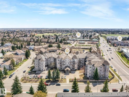 Multi-story residential building featuring light-toned siding and dark shingle roofing - 317 2420 108 Street, Edmonton, AB - Outdoor With View