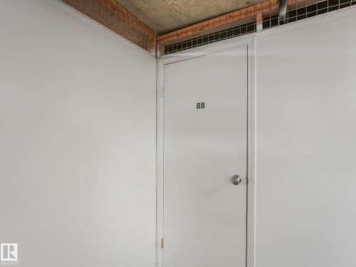 White painted door with a silver knob - 317 2420 108 Street, Edmonton, AB - Indoor Photo Showing Other Room