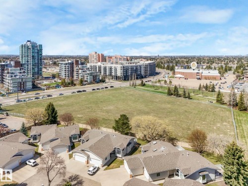 Aerial perspective showcasing residential properties with light-colored siding and shingle roofs - 317 2420 108 Street, Edmonton, AB - Outdoor With View