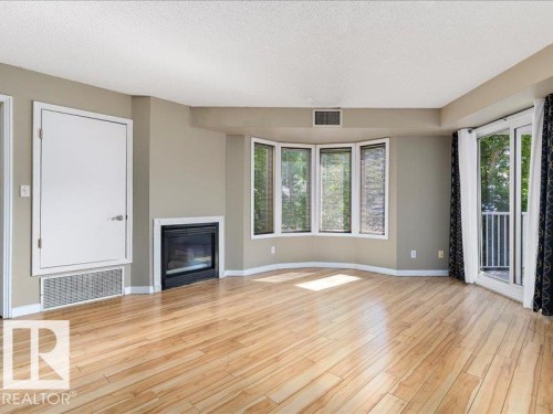 204 9640 105 Street, Edmonton, AB - Indoor Photo Showing Living Room With Fireplace