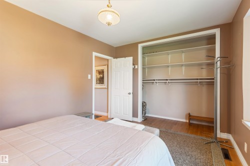 Bedroom featuring a built-in closet with shelving and hanging rods - 10803 52 Street, Edmonton, AB - Indoor Photo Showing Bedroom