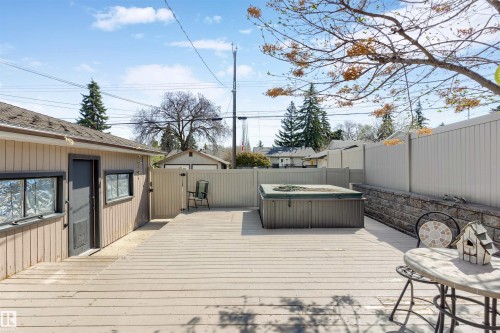 Expansive wood-finish deck featuring an integrated spa - 10803 52 Street, Edmonton, AB - Outdoor With Exterior