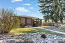 Single-story residence featuring wood-paneled siding and a covered front entry - 10803 52 Street, Edmonton, AB  - Outdoor 