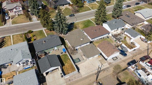Single-story residence featuring a gray shingle roof and a green exterior - 10803 52 Street, Edmonton, AB - Outdoor With View