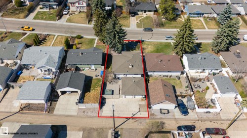 Aerial view of a residential property with a detached garage, concrete driveway, and mature trees - 10803 52 Street, Edmonton, AB - Outdoor With View