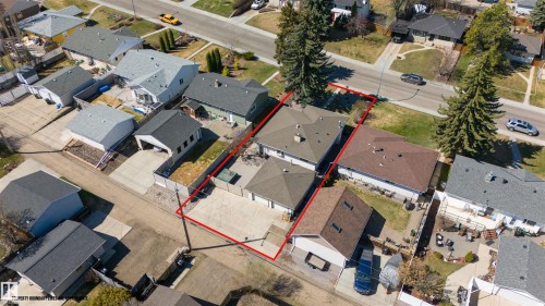 Property featuring a primary residence with a brown shingle roof, accompanied by a detached garage with a grey shingle roof - 10803 52 Street, Edmonton, AB - Outdoor With View