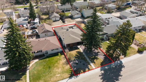 Ranch-style residence featuring a prominent front yard with mature evergreen trees and a paved driveway - 10803 52 Street, Edmonton, AB - Outdoor With View