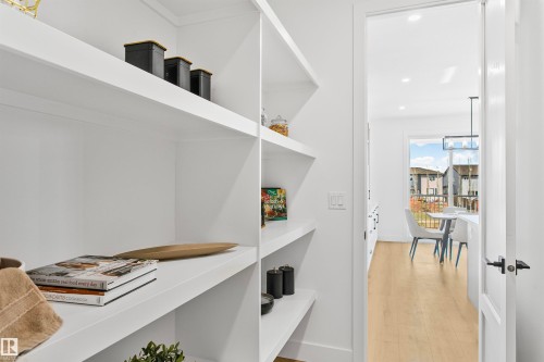 Built-in white shelving system with multiple tiers - 34 Harley Way, Spruce Grove, AB - Indoor
