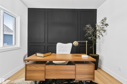 Accent wall featuring black panel molding - 34 Harley Way, Spruce Grove, AB - Indoor Photo Showing Office