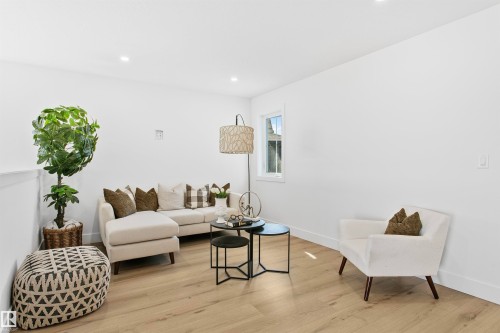 Living space featuring light wood-finish flooring, recessed ceiling lighting, a single pane window, and white baseboards - 34 Harley Way, Spruce Grove, AB - Indoor Photo Showing Living Room