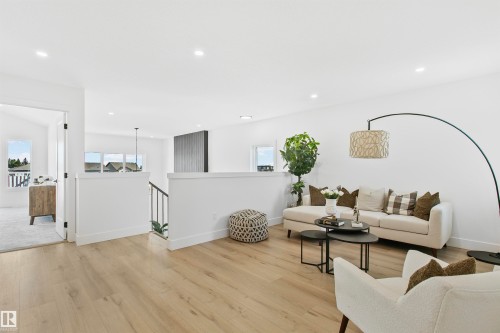 Open concept living space featuring light wood-finish flooring, recessed lighting, and white walls - 34 Harley Way, Spruce Grove, AB - Indoor Photo Showing Living Room