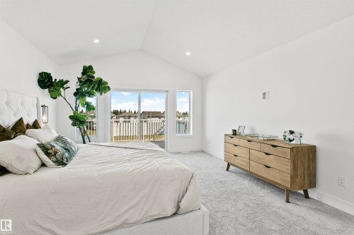 Vaulted ceilings featuring recessed lighting, a sliding glass door leading to an outdoor space, and soft grey carpeting - 34 Harley Way, Spruce Grove, AB - Indoor Photo Showing Bedroom