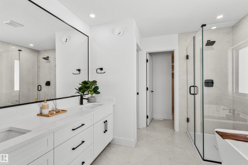 Dual vanity with integrated sinks, white cabinetry, and matte black hardware - 34 Harley Way, Spruce Grove, AB - Indoor