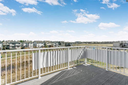 Outdoor balcony featuring composite decking, white metal railings, and privacy screening - 34 Harley Way, Spruce Grove, AB - Outdoor With View
