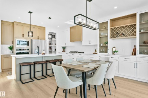Open-concept kitchen and dining area featuring light wood-finish flooring - 34 Harley Way, Spruce Grove, AB - Indoor Photo Showing Other Room