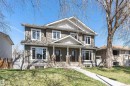 Duplex with two distinct entrances featuring a neutral siding facade and white trim - 8530 76 Avenue, Edmonton, AB  - Outdoor With Deck Patio Veranda With Facade 