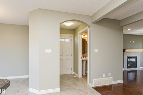 Entryway featuring light-toned tile flooring and an arched doorway - 8530 76 Avenue, Edmonton, AB - Indoor Photo Showing Other Room