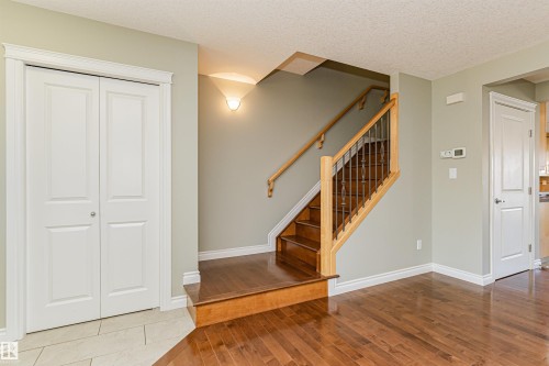 Hardwood flooring throughout the main area with tile flooring near the double-door closet - 8530 76 Avenue, Edmonton, AB - Indoor Photo Showing Other Room