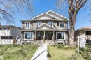 Two-story duplex featuring shake and lap siding, multiple gables, and individual covered entryways with stone-clad columns - 8530 76 Avenue, Edmonton, AB  - Outdoor With Deck Patio Veranda With Facade 