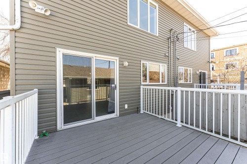 Spacious outdoor deck featuring gray composite decking and white railings - 8530 76 Avenue, Edmonton, AB - Outdoor With Deck Patio Veranda With Exterior