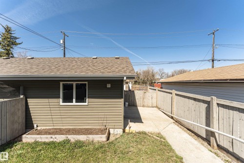 Detached structure featuring horizontal siding, a shingle roof, and a white-framed window - 8530 76 Avenue, Edmonton, AB - Outdoor With Exterior