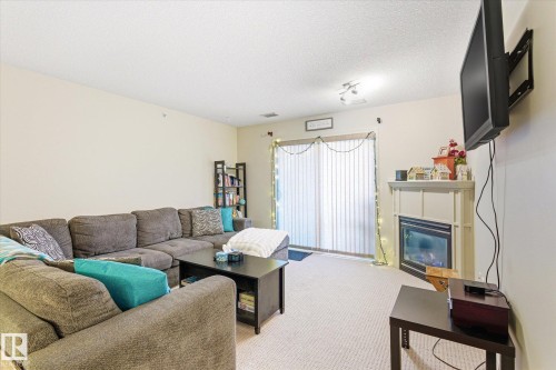 410 7909 71 Street, Edmonton, AB - Indoor Photo Showing Living Room With Fireplace