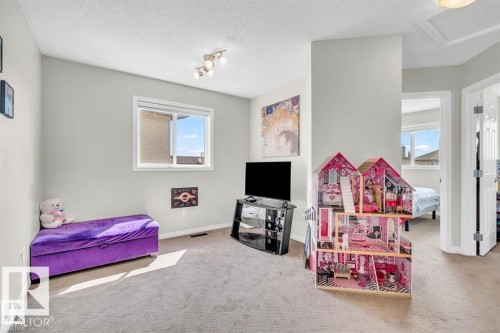 Carpeted room featuring a single window with white trim, light gray walls, and a white ceiling with a flush-mounted light fixture - 21223 92 Avenue, Edmonton, AB - Indoor