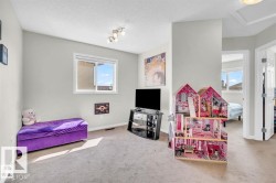 Carpeted room featuring a single window with white trim, light gray walls, and a white ceiling with a flush-mounted light fixture - 