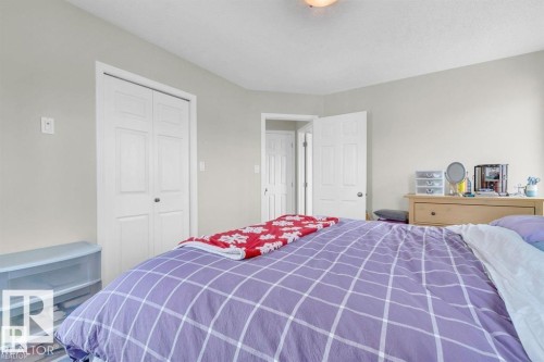 Bedroom featuring light gray wall paint, white trim, white paneled doors, and a ceiling-mounted light fixture - 21223 92 Avenue, Edmonton, AB - Indoor Photo Showing Bedroom