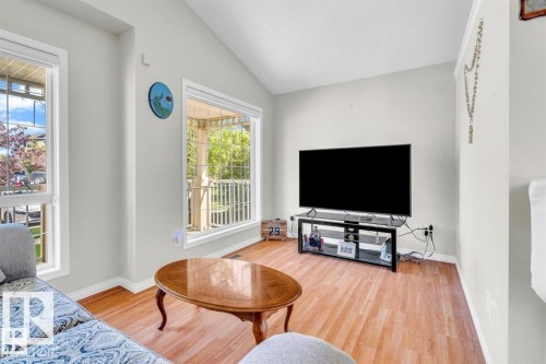 Living area with vaulted ceilings and wood-finish flooring - 21223 92 Avenue, Edmonton, AB - Indoor Photo Showing Living Room