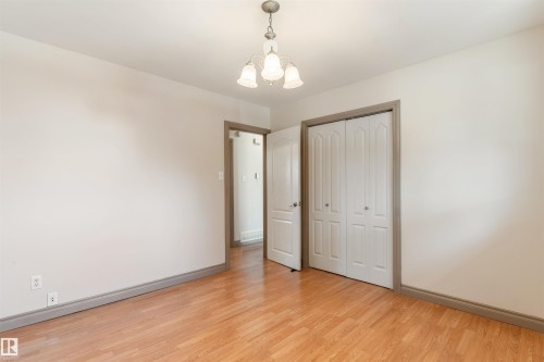 Neutral wall tones with wood-finish flooring - 10620 68 Avenue, Edmonton, AB - Indoor Photo Showing Other Room