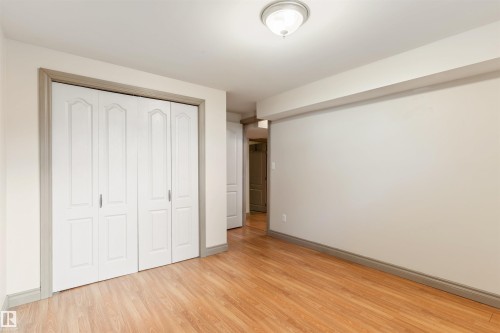 Room featuring wood-finish flooring, white walls, and a ceiling-mounted light fixture - 10620 68 Avenue, Edmonton, AB - Indoor Photo Showing Other Room