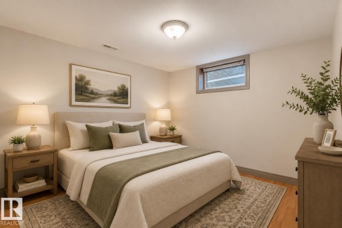 Room featuring wood-finish flooring, light-toned walls, and a ceiling-mounted light fixture - 10620 68 Avenue, Edmonton, AB - Indoor Photo Showing Bedroom