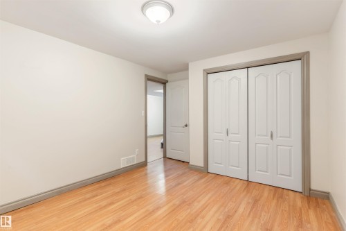 Room featuring wood-finish flooring, light-toned walls, and a ceiling-mounted light fixture - 10620 68 Avenue, Edmonton, AB - Indoor Photo Showing Other Room