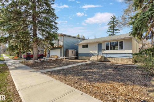 Ranch-style residence featuring a stucco and siding exterior, multiple windows, and a front entry with steps - 10620 68 Avenue, Edmonton, AB - Outdoor