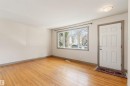 Warm wood-finish flooring complements the neutral wall tones - 10620 68 Avenue, Edmonton, AB  - Indoor Photo Showing Other Room 