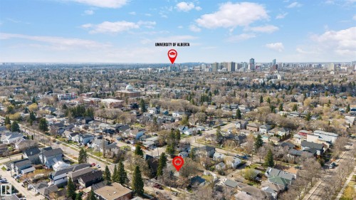 Aerial perspective showcasing an urban residential neighborhood with a distant cityscape and prominent university campus - 10620 68 Avenue, Edmonton, AB - Outdoor With View