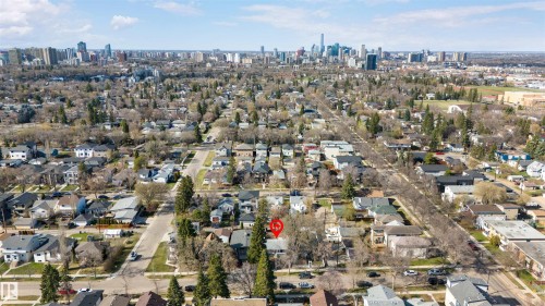 Aerial perspective showcasing a residential neighborhood with a distant cityscape - 10620 68 Avenue, Edmonton, AB - Outdoor With View