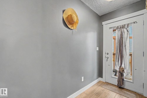 White door with glass paneling opens to an outdoor space - 210 401 Southfork Drive, Leduc, AB - Indoor Photo Showing Other Room