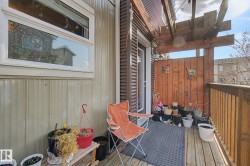Private outdoor deck featuring wood flooring and a privacy wall - 