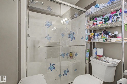 Walk-in shower with clear glass enclosure and chrome hardware - 210 401 Southfork Drive, Leduc, AB - Indoor Photo Showing Bathroom