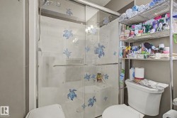 Walk-in shower with clear glass enclosure and chrome hardware - 