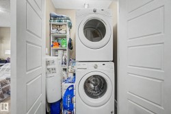 Dedicated laundry closet featuring a stacked washer and dryer unit - 
