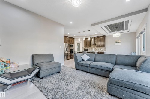 Open-concept living space featuring wood-finish flooring and recessed lighting - 1103 29 Street, Edmonton, AB - Indoor Photo Showing Living Room