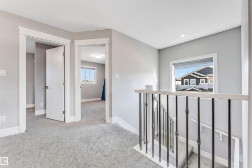 Upper-level landing featuring light gray carpeting and walls - 1103 29 Street, Edmonton, AB - Indoor Photo Showing Other Room