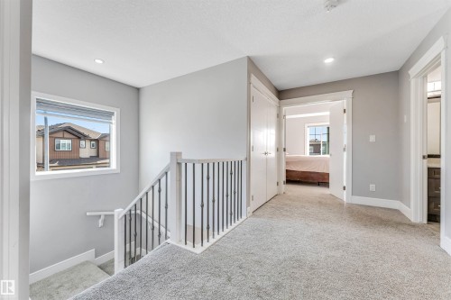 Upper-level landing featuring light gray carpeting, white trim, and recessed lighting - 1103 29 Street, Edmonton, AB - Indoor Photo Showing Other Room