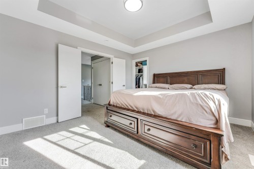Recessed tray ceiling with central flush-mount lighting - 1103 29 Street, Edmonton, AB - Indoor Photo Showing Bedroom