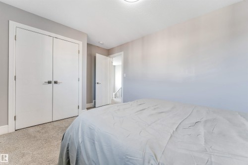 Bedroom featuring light grey walls, white trim, and neutral-toned carpet - 1103 29 Street, Edmonton, AB - Indoor Photo Showing Bedroom