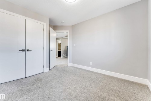 Room featuring light gray carpeting, white baseboards, and a neutral wall color - 1103 29 Street, Edmonton, AB - Indoor Photo Showing Other Room