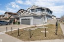 Modern two-story residence featuring light blue siding, darker blue upper paneling, a two-car garage, and a light-toned privacy fence - 1103 29 Street, Edmonton, AB  - Outdoor With Facade 